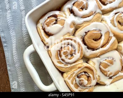 Cinnamon rolls in a white baking dish Stock Photo