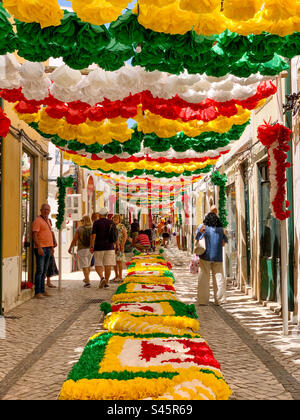 Streets decorated with paper flowers and displays for Festa Dos Tabuleiros in Tomar, Portugal 2023. Stock Photo