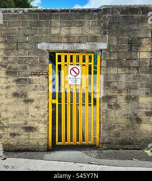 ‘No transfers between stands’ a yellow gate with clear sign for supporters outside The Shay Stadium - home of F.C. Halifax Town. Stock Photo