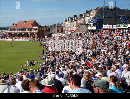 A large crowd at a one day limited-overs cricket match at Yorkshire’s Scarborough Cricket Ground. Originally created in 1849, Scarborough Cricket Club has a distinguished history and Festival. Stock Photo