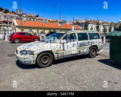 Old battered Volvo V70 estate car with metal panels in Lisbon Stock Photo