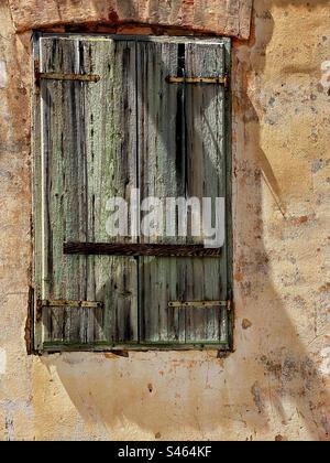 Old faded shutter on a derelict building in Vbroska, Hvar, Croatia. Stock Photo