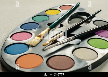 A paint palette and brushes Stock Photo