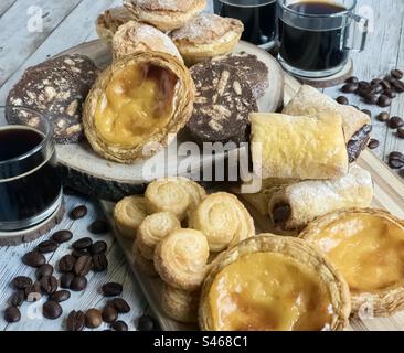 Black coffees and assorted pastries Stock Photo