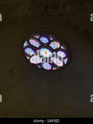 Abstract circular stained glass window in a church Stock Photo