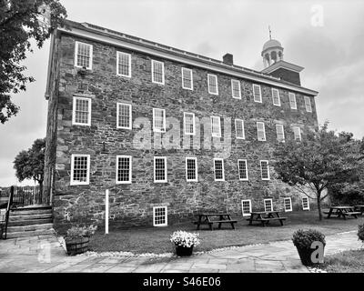 Black and white of Old Slater Mill National Historic Landmark in Pawtucket, Rhode Island, USA. Stone building. First water powered textile mill in America. Stock Photo