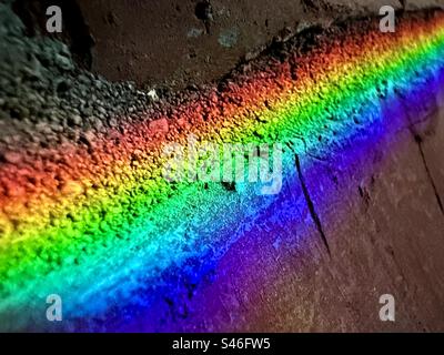 Rainbow colors reflected into a brick wall Stock Photo