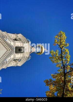 Autumn colored tree branch and onion dome of the Orthodox Church in Karlovy Vary built in the 19th century, Czech Republic. Stock Photo