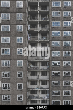 Full frame architecture background of an old and condemned derelict tower block in the UK  from the Sixties with concrete walls and old balconies with broken windows Stock Photo