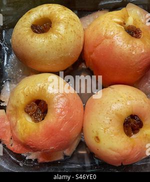 Baked apples stuffed with dried fruits in a baking tray Stock Photo