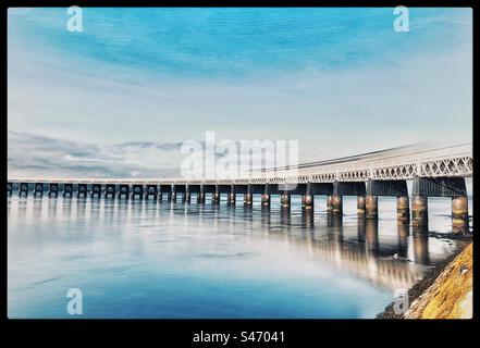 Long exposure of a train heading over the Tay Rail Bridge, Dundee. Stock Photo