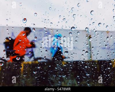 View of a rainy day from inside a car with water droplets on the window Stock Photo