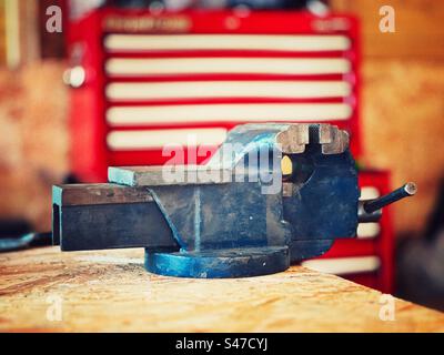 Vintage engineers metalworking vice against red and white background Stock Photo