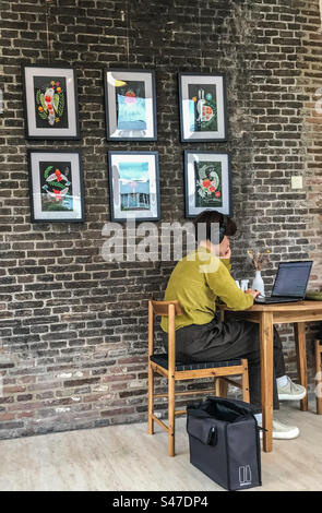 Young woman studying and teleworking in the library Stock Photo
