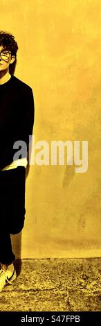 Half a young man in black and yellow. Stock Photo