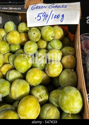 Greengages priced up for sale at Grocers shop Stock Photo