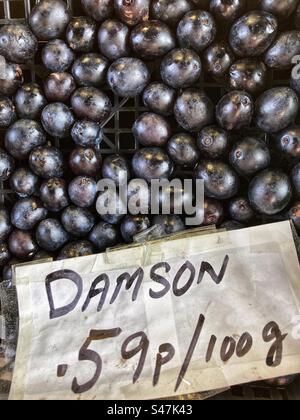 Damson priced up for sale at Grocers shop Stock Photo