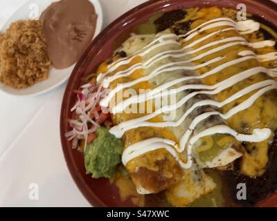 Close up of a special enchilada entrée with a side of refried beans and Spanish rice at the upscale, Mexican restaurant, El Rio grande, 2023, New York City, USA Stock Photo