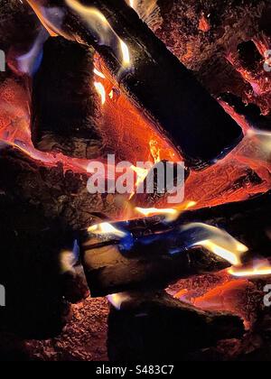 A closeup view of the inside of an outdoor fire pit. The wood has burned down to be pretty much just red hot coals. A fine fiery abstract. Stock Photo