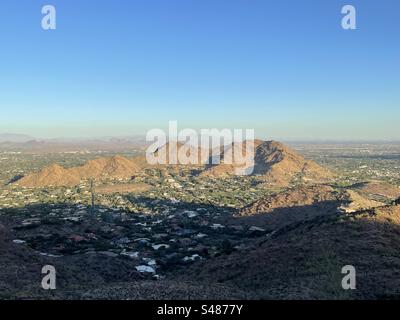 Mummy mountain with setting sun glow, view from hiking trail, banded blue and orange sunset, Phoenix Mountains Preserve, Paradise Valley, Arizona Stock Photo