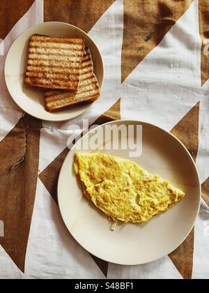 Top view of an omelette and toast for breakfast Stock Photo