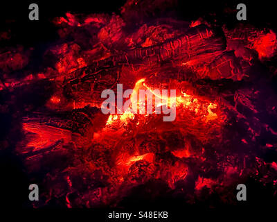 Glowing logs in a campfire Stock Photo