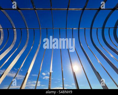 Abstract of safety barrier on viewing platform of the Empire State Building Building against the sun and a vivid blue sky Stock Photo
