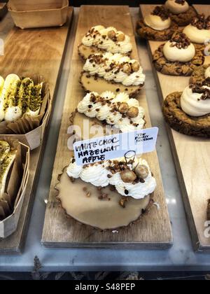 White chocolate hazelnut apple tart cake in bakery shop window Stock Photo