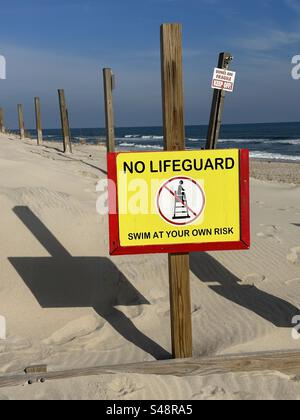 USA Maryland Assateague Island beach no lifeguard on duty sign and keep off dunes sign on beach Stock Photo