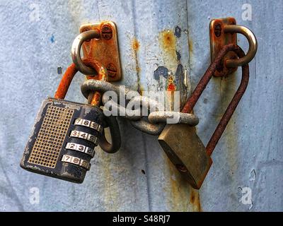 Rusting padlocks exposed to the elements outdoors Stock Photo