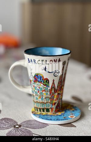 Decorated Barcelona mug on a home table and matching coaster. Stock Photo