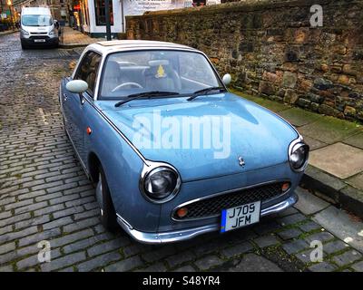 Nissan Figaro car, retro styled parked in street Stock Photo