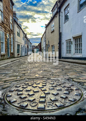 Cobblestone street and quaint houses on Henrietta Street in Whitby North Yorkshire Stock Photo