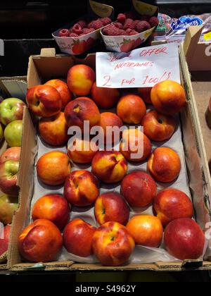 Nectarines priced up for sale at Grocer’s shop Stock Photo