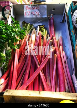 Rhubarb priced up for sale at Grocer’s shop Stock Photo