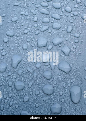 Raindrops on a grey metallic surface Stock Photo