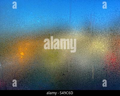 Bright colours seen in abstract through condensation on window Stock Photo