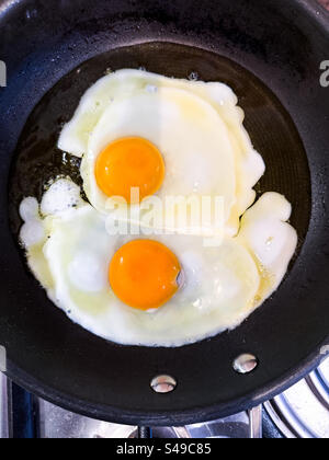 Two fried eggs in a frying pan Stock Photo