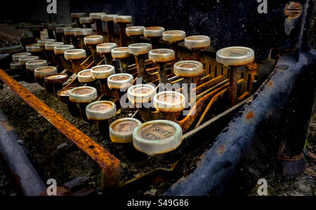 Close up of rusted and discarded antique metal typewriter Stock Photo