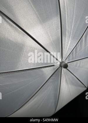 light shining through a white photography umbrella Stock Photo