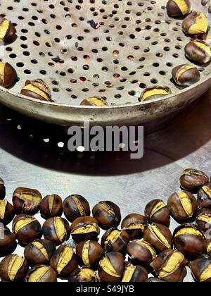 Hot roasted chestnuts at street vendor in Athens, Greece. Tasty delicacy Stock Photo