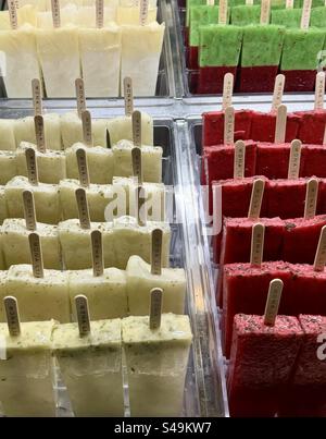 Assorted colorful popsicles in different flavors displayed on sticks in an ice cream shop in Athens, Greece. Stock Photo