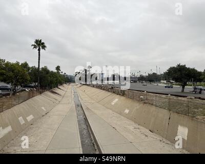 LOS ANGELES, CA, SEP 6, 2023, View along concrete-lined Arroyo Seco river, near the Rose Bowl Stadium in Pasadena, California, overcast sky above Stock Photo
