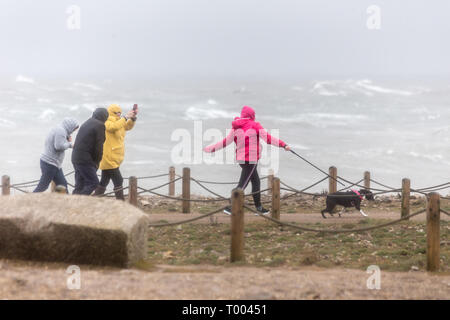 Portland, Dorset. 16th March 2019. The exposed southern coast of Portland Bill in Dorset are battered by gale force winds and colossal waves as members of the public brave the extreme conditions with gusts peaking at 70mph. Credit: Wayne Farrell/Alamy News Stock Photo