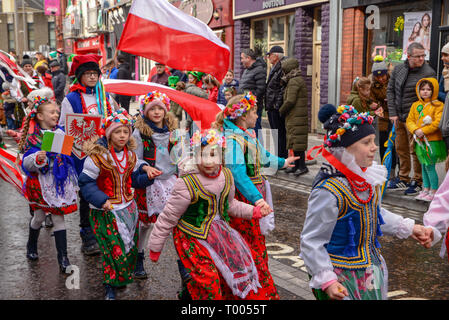 Athlone Town, Ireland. 16th March 2019. Polish families marching in the 2019 Athlone St. Patrick's Day Parade wearing traditional and colorful Polish outfits. Credit: Eoin Healy/Alamy Live News Stock Photo