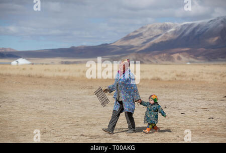 bayan Ulgii, Mongolia, 29th September 2015: mongolian kazakh nomad woman with her son in a landscape of Western Mongolia Stock Photo