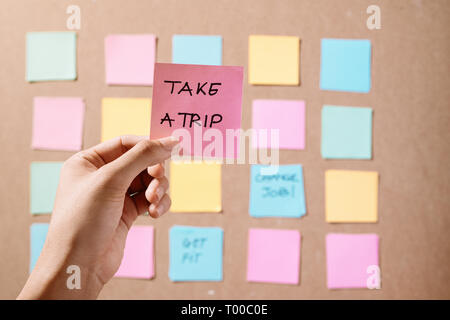 Motivational word 'Take a trip' on pink card Stock Photo