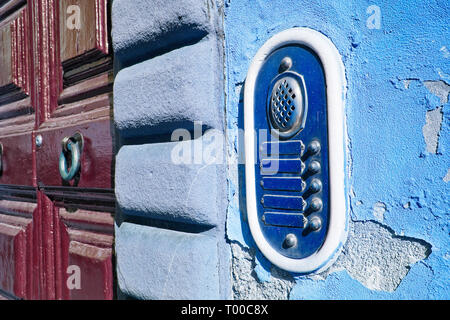 Old colored bell system on blue plaster (Tuscany - Italy) Stock Photo