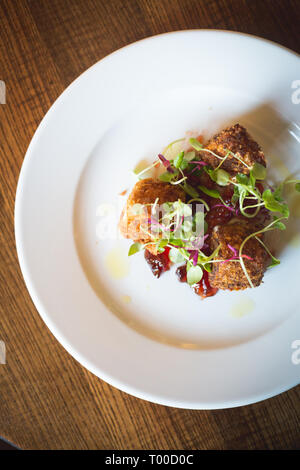 deep fried cheese balls on cranberry sauce Stock Photo