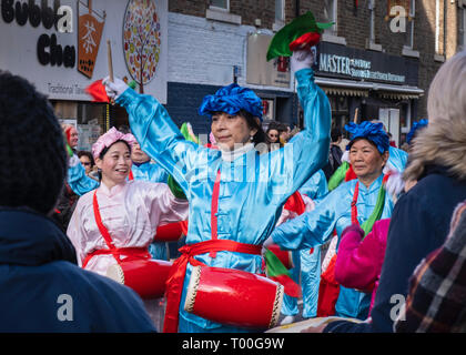 Enthusiastic female drummer celebrating in parade during the Newcastle upon Tyne Chinese New Year celebrations Stock Photo